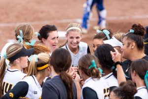 Iowas Allison Doocy smiles between innings with her teammates during a softball game against Des Moines Area Community College on Friday, Sep. 21, 2018. The Hawkeyes defeated the Bears 8-1.