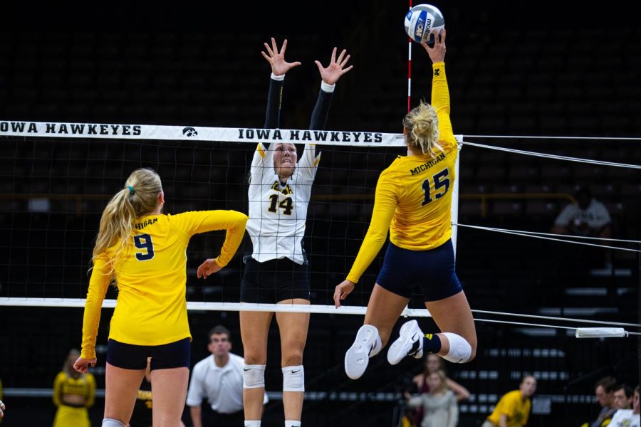 Cali Hoye attempts to block the incoming spike during Iowas match against Michigan at Carver-Hawkeye Arena on September 23, 2018. The Hawkeyes were defeated 3-1. (Megan Nagorzanski/The Daily Iowan)