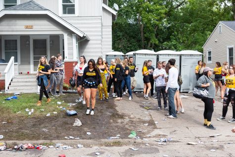 Tailgaters walk out of a party before a football game against Iowa State University on Saturday, Sept. 8, 2018. 
