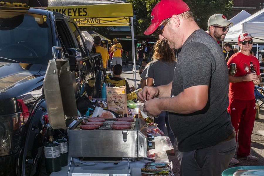 A Badger fan cooks hamburgers outside of Kinnick Stadium on Saturday, September 22, 2018. Both Hawkeye and Badger fans tailgated throughout Iowa City prior to the Iowa vs. Wisconsin  football game. (Katina Zentz/The Daily Iowan)