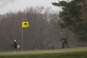 Iowas Matthew Walker walks on the green in a downpour during the Hawkeye Invitational at Finkbine Golf Course on Saturday, April 15, 2017. 