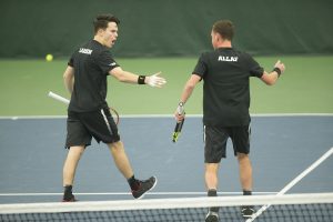 Iowas Kareem Allaf and Jonas Larsen celebrate during a tennis match between Iowa and Western Michigan in Iowa City on Friday, Jan. 19, 2018. The Hawkeyes earned the doubles point but lost the match overall, 5-2.