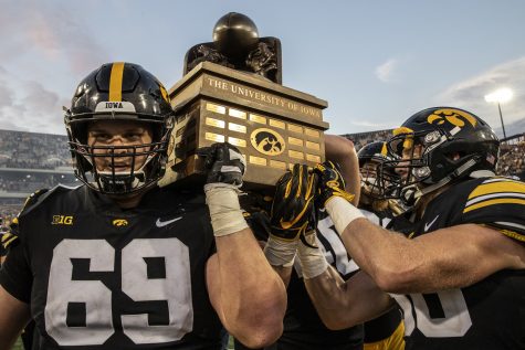 Iowa center Keegan Render and teammates carry the Cy-Hawk trophy off the field after Iowas game against Iowa State at Kinnick Stadium on Saturday, Sept. 8, 2018. The Hawkeyes defeated the cyclones 13-3.