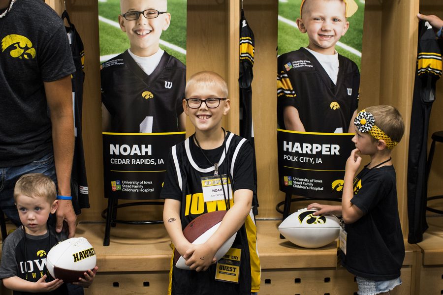 From left: Kid Captains Mason Zabel, Noah Hodgins, and Harper Stribe find their lockers during Iowa Football Kid's Day at Kinnick Stadium on Saturday, August 11, 2018. The 2018 Kid Captains met the Iowa football team and participated in a behind-the-scenes tour of Kinnick Stadium. Each child's story will be featured throughout the 2018 Iowa football season. (Katina Zentz/The Daily Iowan)