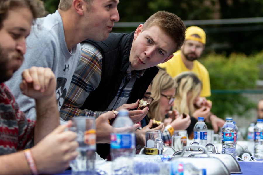 A participant in an eating contest at the Northside Oktoberfest in Iowa City eyes his competition on Saturday, Sep. 29, 2018. Participants had to eat a scotch egg and a bratwurst. (David Harmantas/The Daily Iowan)