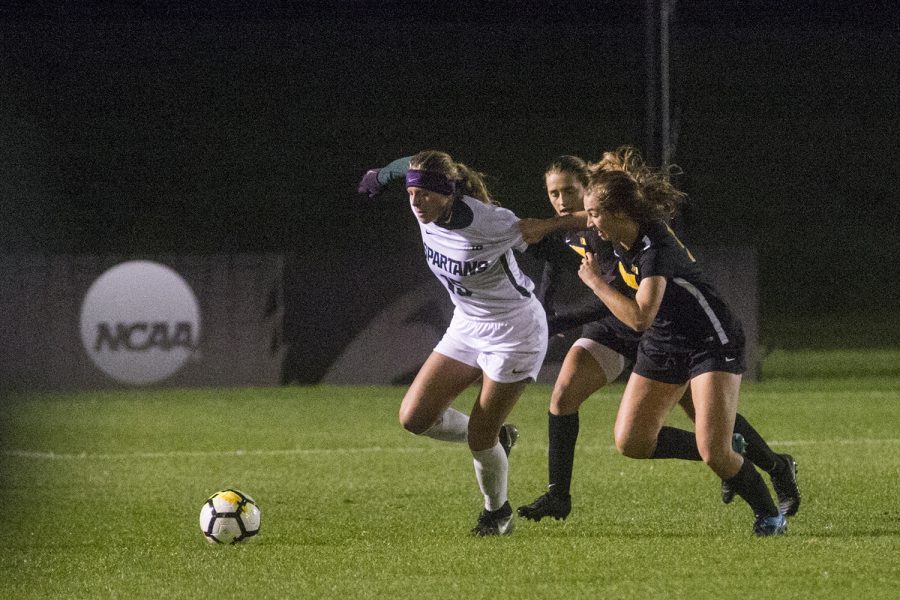 Michigan State freshman Gia Wahlberg goes for the ball as Iowa junior Isabella Blackman (center) and freshman Riley Whitaker (right) follow during the Iowa and Michigan State match at the UI Soccer Complex on Friday Oct. 12, 2018. The Hawkeyes defeated the Spartans 1-0.