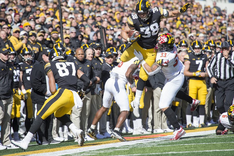 T.J Hockenson (38) jumps Terrapin defender Tre Watson during the Iowa vs. Maryland game at Kinnick stadium on Saturday Oct. 20, 2018. The Hawkeyes defeated the Terrapins 23-0. (Katie Goodale/The Daily Iowan)