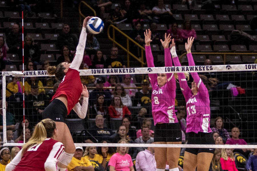 Iowa's Reghan Coyle and Sarah Wing jump up for the block during a volleyball match against Wisconsin on Saturday, Oct. 6, 2018. The Hawkeyes defeated the number six ranked Badgers 3-2. 