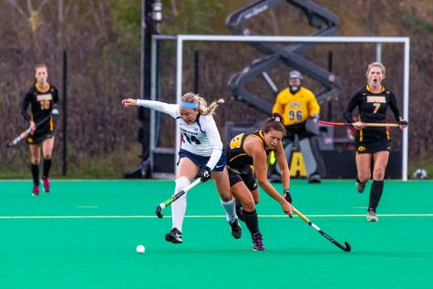Iowa midfielder Mya Christopher battles for possession during a field hockey match against Penn State on Friday, Oct. 12, 2018.