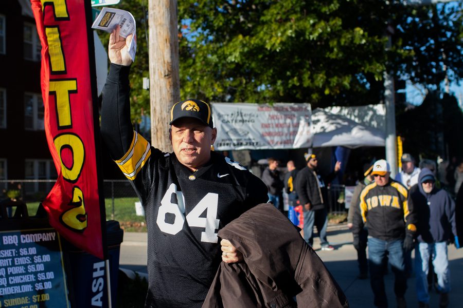 A ticket scalper tries to find a buyer near Kinnick Stadium on Saturday, Oct. 20, 2018.