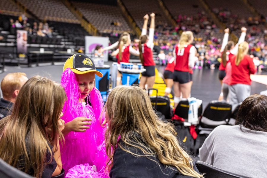 Young fans play with pink pom-poms during a volleyball match against Wisconsin on Saturday, Oct. 6, 2018. The Hawkeyes defeated the number six ranked Badgers 3-2. 