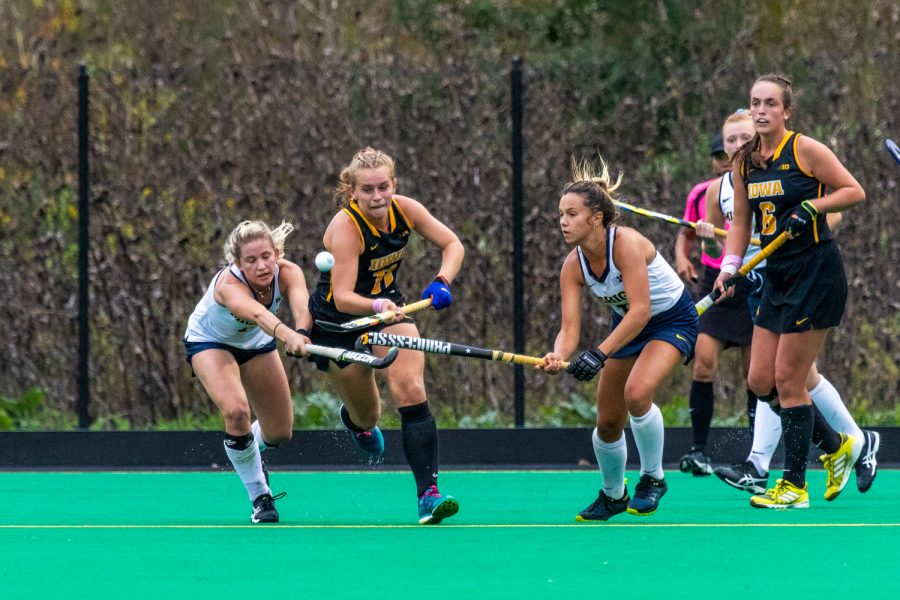 Iowa midfielder Katie Birch fights for possession during a field hockey match against Michigan on Friday, Oct. 5, 2018. The no. 6 ranked Wolverines defeated the no. 10 ranked Hawkeyes 2-1. 