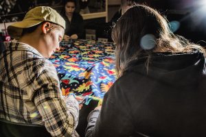 From left: UI freshmen Kyle Braeseke and Autumn Johnson cut a blanket during the Cover to Cover event at the IMU on Monday, October 29, 2018. Cover to Cover is a student organization dedicated to providing children in need with blankets and books. (Katina Zentz/The Daily Iowan)