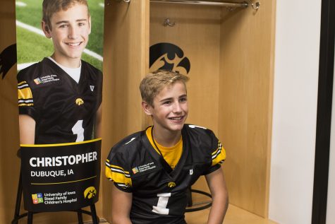 Kid Captain Christopher Turns smiles front of his banner during Iowa Football Kids Day at Kinnick Stadium on Saturday, August 11, 2018. The 2018 Kid Captains met the Iowa football team and participated in a behind-the-scenes tour of Kinnick Stadium. Each childs story will be featured throughout the 2018 Iowa football season. 