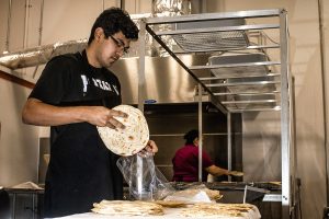 Kavir Ramos puts tortillas into a bag at Tortilla Chihuas on Wednesday, Oct. 17, 2018. Ramos is a DACA recipient and opened the factory to model his grandmothers recipes.