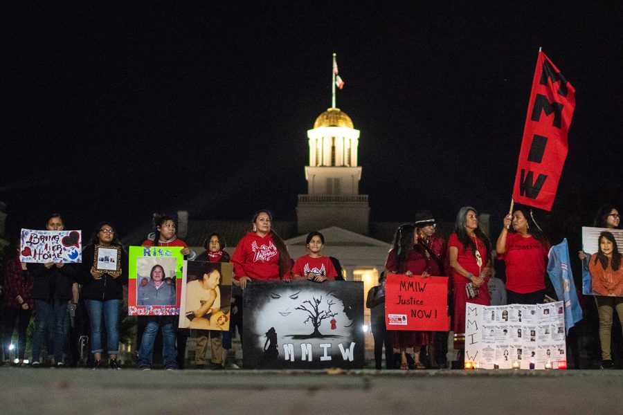 Community members stand in silence during a vigil on the pentacrest on October 8th 2018. The vigil was held in honor of all Missing Murdered Indigenous Women. (Megan Nagorzanski/The Daily Iowan)