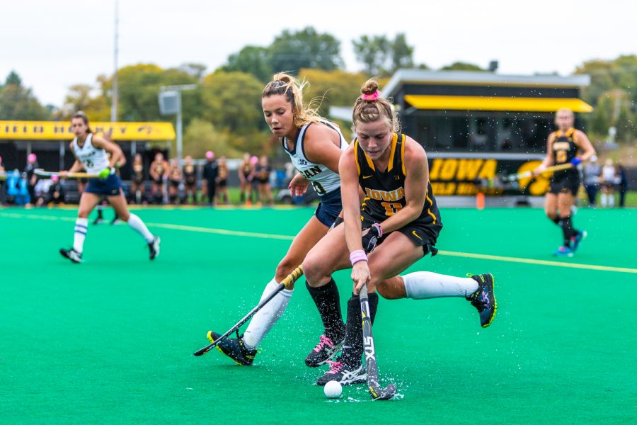 Iowa midfielder Nikki Freeman fights for control of the ball during a field hockey match against Michigan on Friday, Oct. 5, 2018. The no. 6 ranked Wolverines defeated the no. 10 ranked Hawkeyes 2-1. 