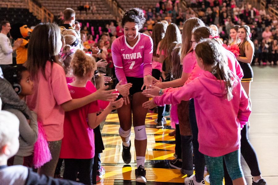 Iowa's Brie Orr runs through a gauntlet of young fans as the starting lineups are introduced before a volleyball match against Wisconsin on Saturday, Oct. 6, 2018. The Hawkeyes defeated the number six ranked Badgers 3-2. 