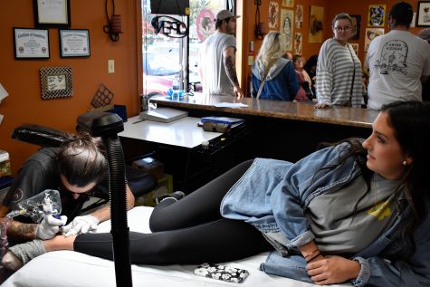 Kinsey Phipps receives a crescent moon tattoo at Velvet Lotus Tattoo shop on Sunday, October 28, 2018. The shop hosted their second annual Halloween charity event called Tats for Tots. (Sid Peterson/The Daily Iowan)