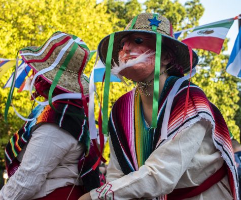 Masked dancers entertain at the annual Latino Festival on Sunday, Sept. 23, 2018. The event took place in front of the Iowa City Senior Center on Linn Street. 
