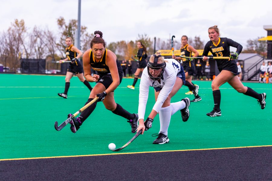 Iowa midfielder Mya Christopher fights for control of the ball along the sideline during a field hockey match against Penn State on Friday, Oct. 12, 2018. The no. 8 ranked Hawkeyes defeated the no. 6 ranked Nittany Lions 3-2. (David Harmantas/The Daily Iowan)