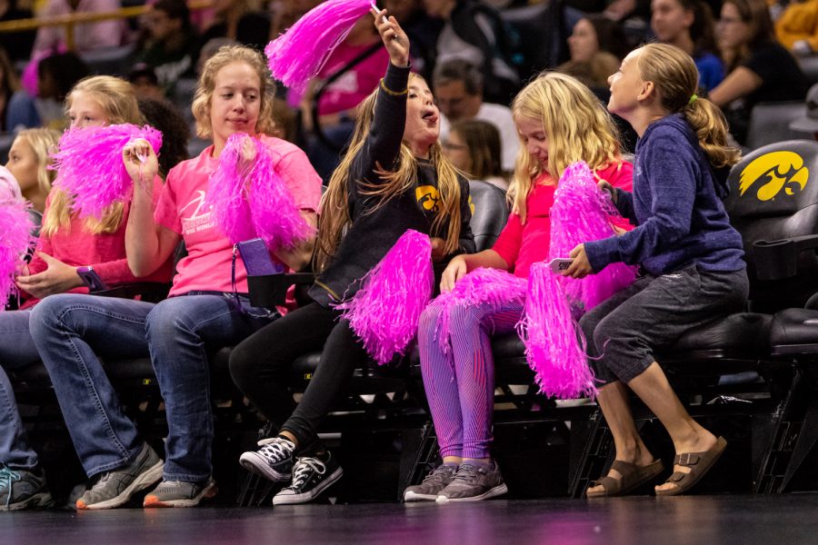 Young fans fight with pink pom-poms during a volleyball match against Wisconsin on Saturday, Oct. 6, 2018. The Hawkeyes defeated the number six ranked Badgers 3-2. 