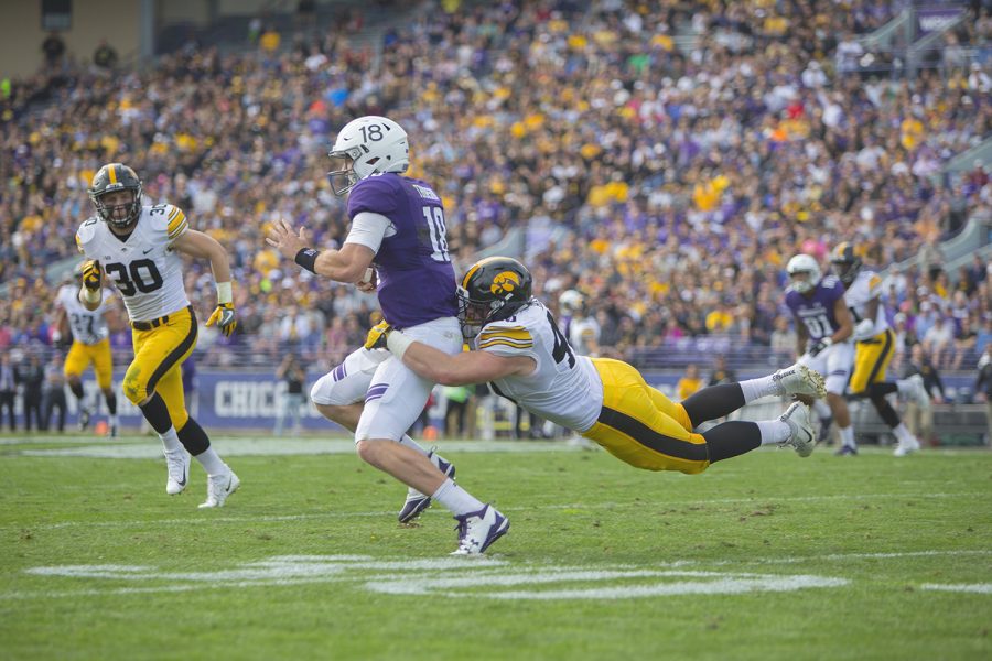 Iowa defensive end Parker Hesse tackles Northwestern quarterback Clayton Thorson during the game between Iowa and Northwestern at Ryan Field in Evanston on Saturday, Oct. 21, 2017.