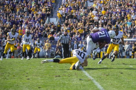Iowa defensive back Jake Gervase tackles Northwestern running back Justin Jackson during the game between Iowa and Northwestern at Ryan Field in Evanston on Saturday, Oct. 21, 2017. The Wildcats defeated the Hawkeyes, 17-10, in overtime. 