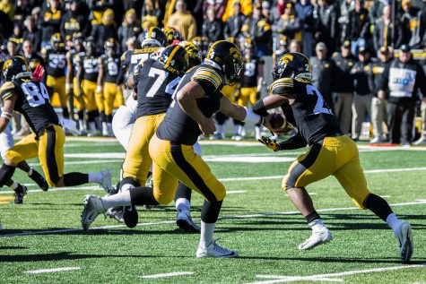 Iowa quarterback Nate Stanley hands the ball off to running back Ivory Kelley-Martin during a football game between Iowa and Maryland in Kinnick Stadium on Saturday, October 20, 2018. The Hawkeyes defeated the Terrapins, 23-0.