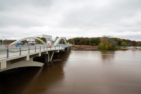The rain-swollen Iowa river flows by the new Park Rd. Bridge and Dubuque St on Wednesday, Oct. 10, 2018.