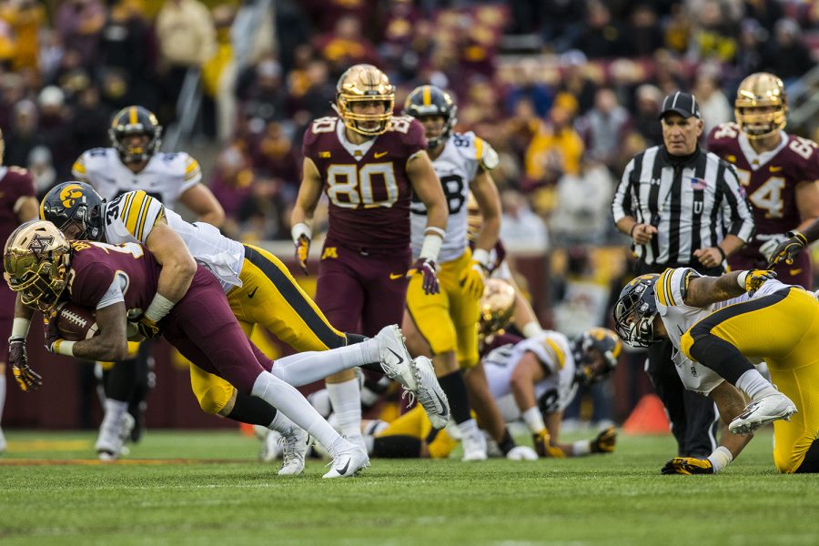 Iowa's Jake Gervase tackles Minnesota's Rashad Bateman during the Iowa/Minnesota football game at TCF Bank Stadium in Minneapolis on Saturday, October 6, 2018. The Hawkeyes defeated the Golden Gophers, 48-31. 