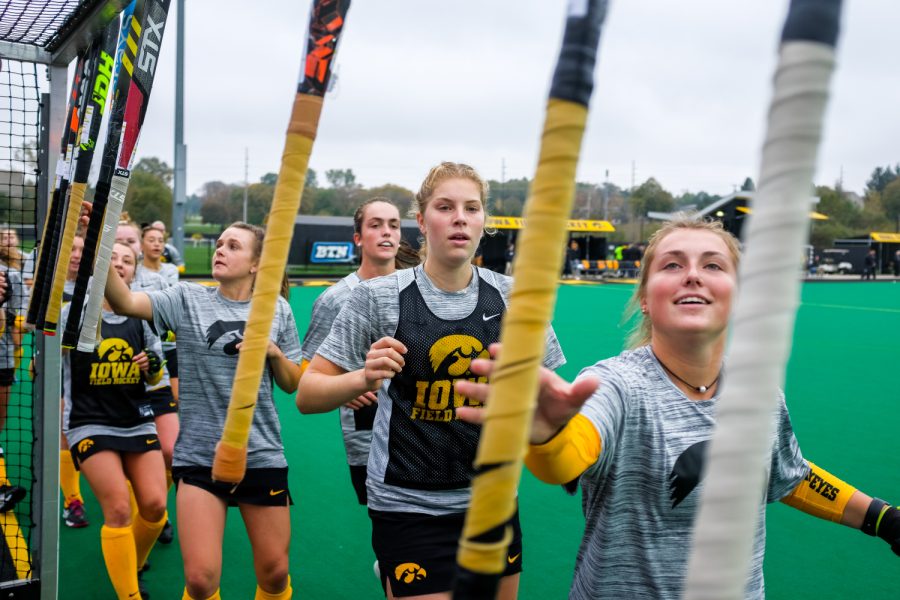 Iowa field hockey players grab their sticks before a field hockey match against Maryland on Sunday, Oct. 14, 2018. The no. 2 ranked Terrapins defeated the no. 8 ranked Hawkeyes 2-1. 