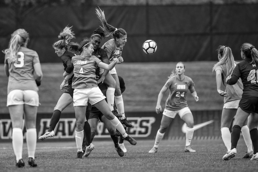Players fight for a cross during Iowas game against Michigan at The Hawkeye Soccer Complex on Sunday, October 14, 2018. The Hawkeyes defeated the Wolverines 1-0.
