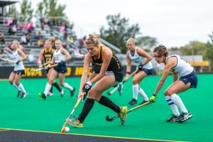 Iowa midfielder Ellie Holley fights to control the ball along the sideline during a field hockey match against Michigan on Friday, Oct. 5, 2018. The no. 6 ranked Wolverines defeated the no. 10 ranked Hawkeyes 2-1. 