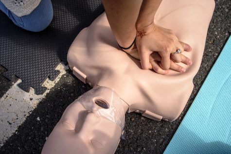 The hands of a student compress the chest of a CPR mannequin during a community training session on July 27, 2018, at the University of St. Joseph in West Hartford, Conn. (Mark Mirko/Hartford Courant/TNS)