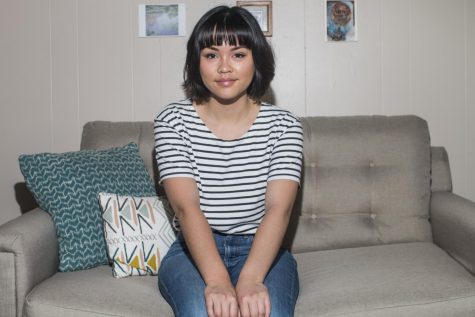 Isabella Rosario sits in her apartment in Iowa City. 