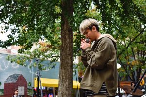 Yusong Ju raps at the University of Iowa Chinese Music Clubs outdoor performance at the Iowa City Ped Mall on Saturday, Oct. 13, 2018.