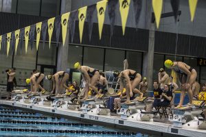Swimmers line up on the blocks during the Iowa Swimming and Diving Intrasquad Meet at the Campus Recreation and Wellness Center on Saturday, Sept. 29, 2018. 