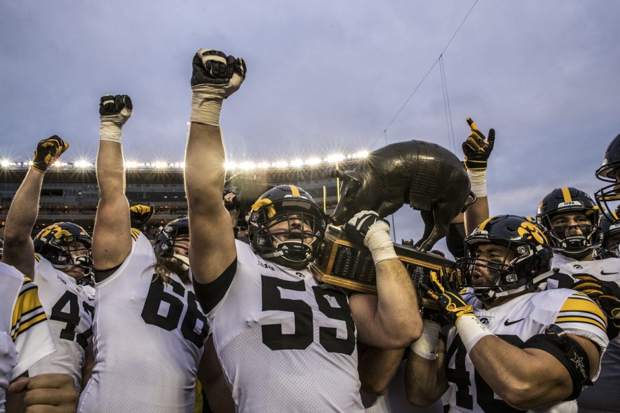 Iowa players hold the Floyd of Rosedale trophy after  their game against Minnesota at TCF Bank Stadium on Saturday, October 6, 2018. The Hawkeyes defeated the Golden Gophers 48-31.