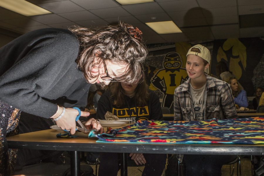 UI freshman Keaton Scandrett cuts a blanket during the Cover to Cover event at the IMU on Monday, Oct. 29, 2018. Cover to Cover is a student organization dedicated to providing children in need with blankets and books.