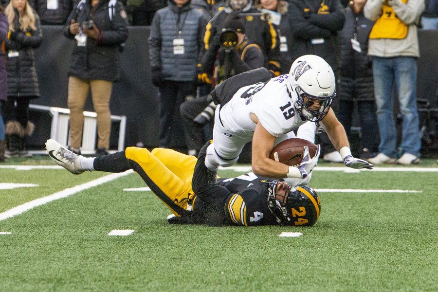 Northwestern wide receiver Riley Lees jumps over Iowa defensive back Josh Turner during the Iowa/Northwestern game at Kinnick Stadium on Saturday, November 10, 2018. The Wildcats defeated the Hawkeyes 14-10. (Katina Zentz/The Daily Iowan)