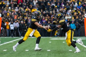 Iowa quarterback Nate Stanley (4) hands off to Iowa running back Ivory Kelly-Martin (21) during a game against Northwestern University on Saturday, Nov. 10, 2018 at Kinnick Stadium. The Wildcats defeated the Hawkeyes 14-10. 