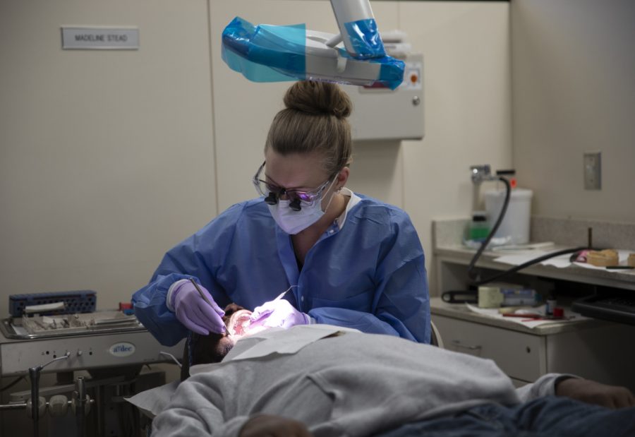 U.S. Army veteran Kenny Williams undergoes a dental procedure from fourth-year student Madeline Stead at the UI College of Dentistry on Tuesday, Nov. 13, 2018. Thanks to a program called Veterans for Everyone, servicemen and women like Williams have gained access to dental care at no cost.