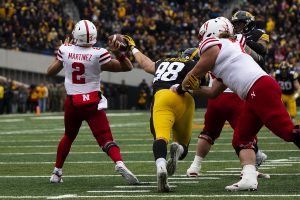 Iowa defensive end Anthony Nelson attempts to stop Nebraska quarterback Adrian Martinez pass during the Iowa/Nebraska football game at Kinnick Stadium on Friday, November 23, 2018. The Hawkeyes defeated the Huskers, 31-28, with a last second field goal. 