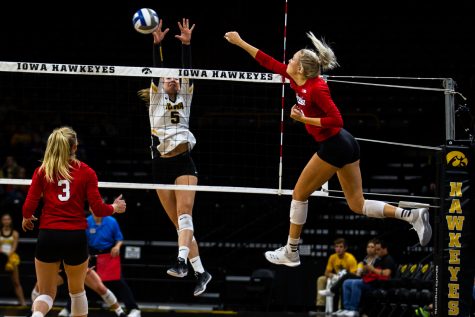 Outside hitter Meghan Buzzerio jumps to block a spike during Iowas game against Nebraska at Carver-Hawkeye Arena on November 7, 2018. The Hawkeyes were defeated 0-3.
