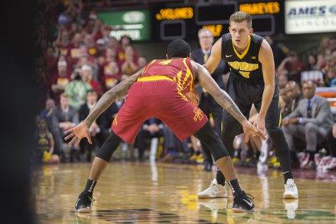 Iowas Jordan Bohannon is guarded by Iowa States Donovan Jackson during the Iowa Corn CyHawk Series mens basketball game at Hilton Coliseum in Ames on Thursday, Dec. 7, 2017. The Cyclones defeated the Hawkeyes, 84-78. 