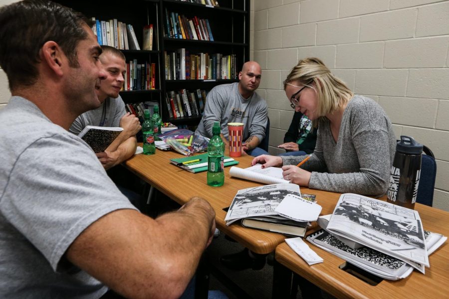 Inside and outside students collaborate on a project before a "One Community, One Book" class at Oakdale Prison on Thursday, Oct. 25, 2018. 