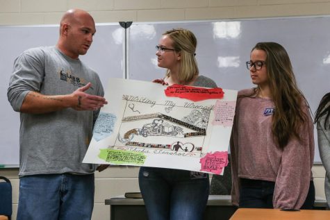 Students present a group project during a One Community, One Book class at the Oakdale prison on Oct. 25. The class is offered once a year through the UI Center for Human Rights. 