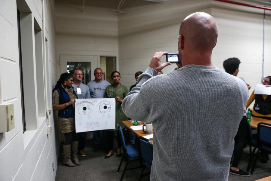 A photographer for Oakdale's community newsletter "The Oakdale Voice" takes a picture during a "One Community, One Book" class at Oakdale Prison on Thursday, Oct. 25, 2018. The newsletter is almost entirely run by inmates and gives them the opportunity to write, take pictures, and provide details of upcoming events in the prison. 