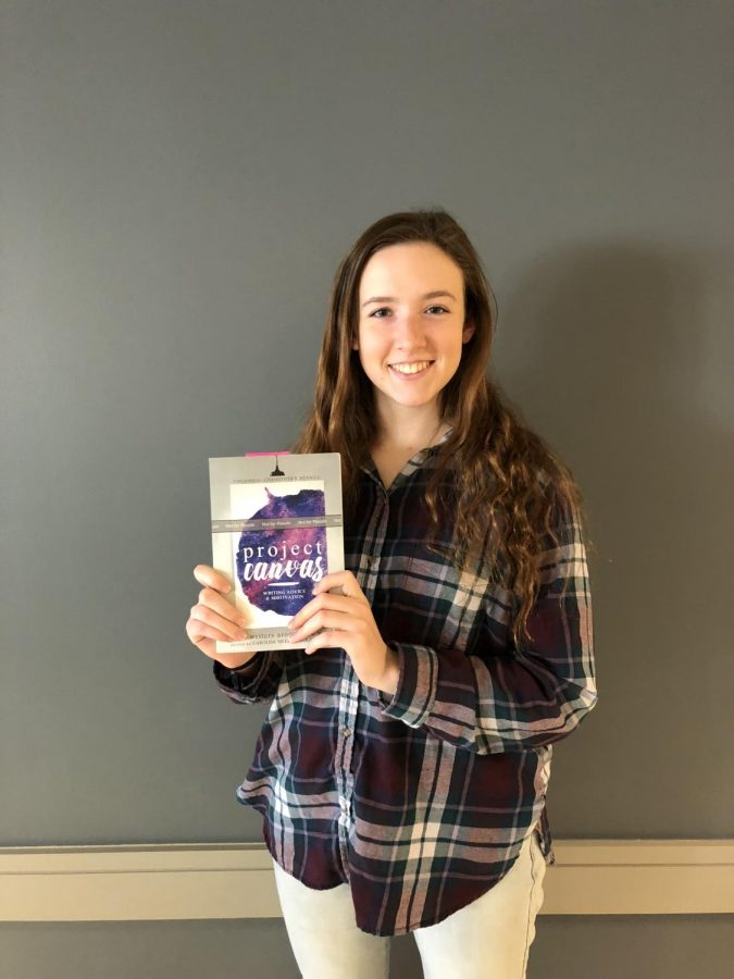 Caroline Meek poses with her book, Project Canvas